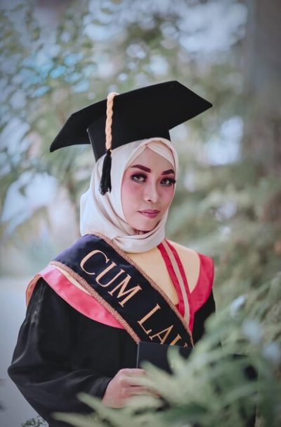 portrait-woman-wearing-graduation-gown-while-standing-against-tree_1048944-5550458